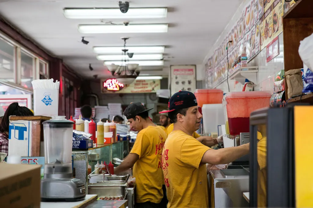 Restaurant workers prep food in a kitchen