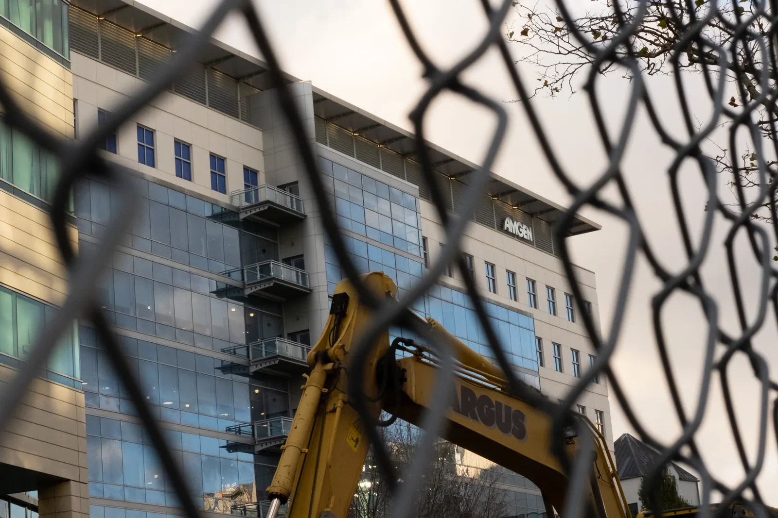 A building is seen through a fence.