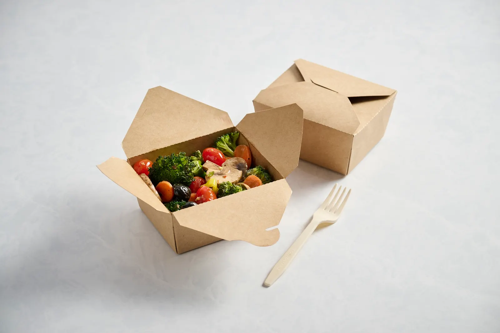 Two natural-colored foodservice boxes, one containing a salad.