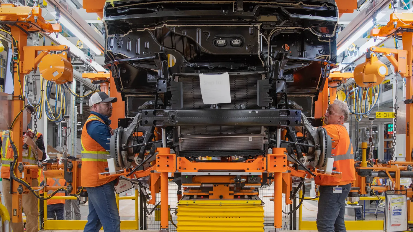 Two employees work on the production line at General Motors' CAMI Assembly plant in Ingersoll, Ontario.