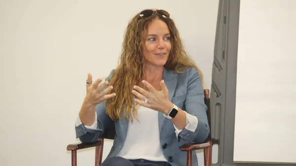 a woman speaks on a panel