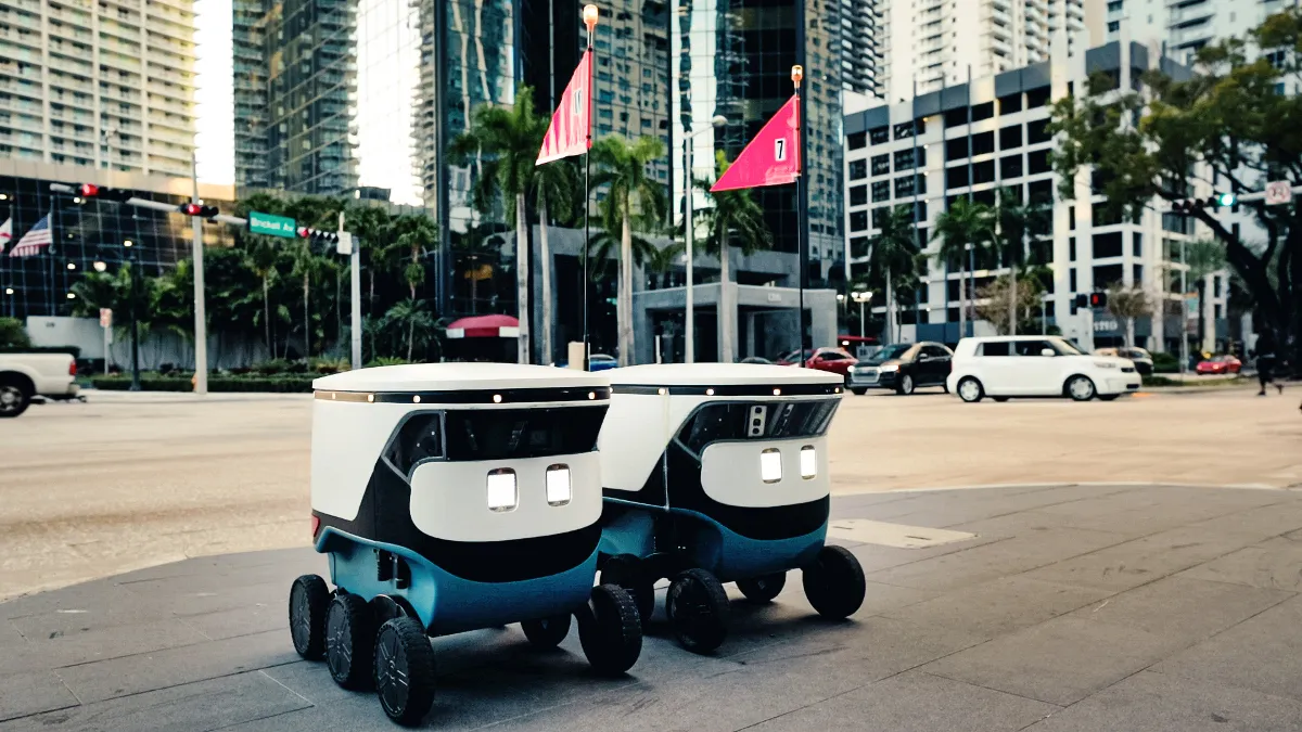 An image of two autonomous delivery bots on a Miami street.