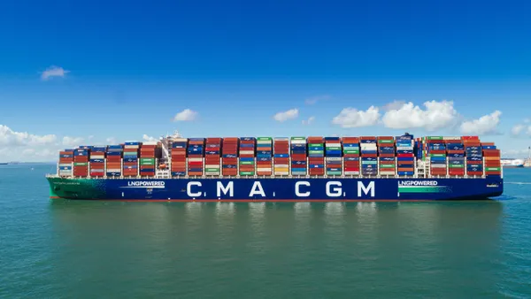 A container ship on the water is emblazoned with the words "CMA CGM" and "LNG Powered"