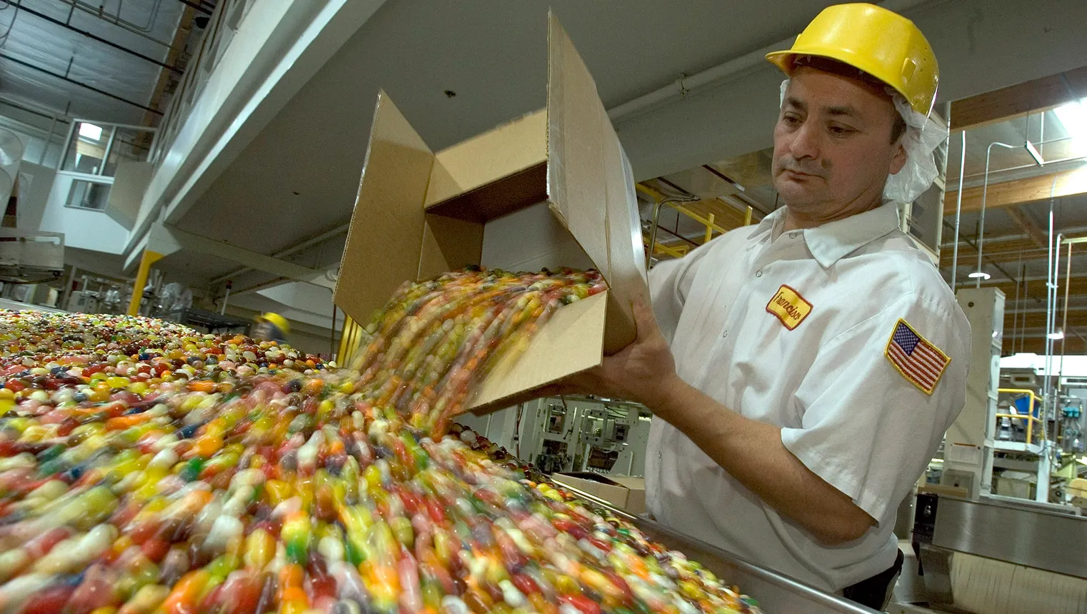 Francisco Tril empties jelly beans for packaging at the Jelly Belly Factory April 2, 2007 in Fairfield, California.