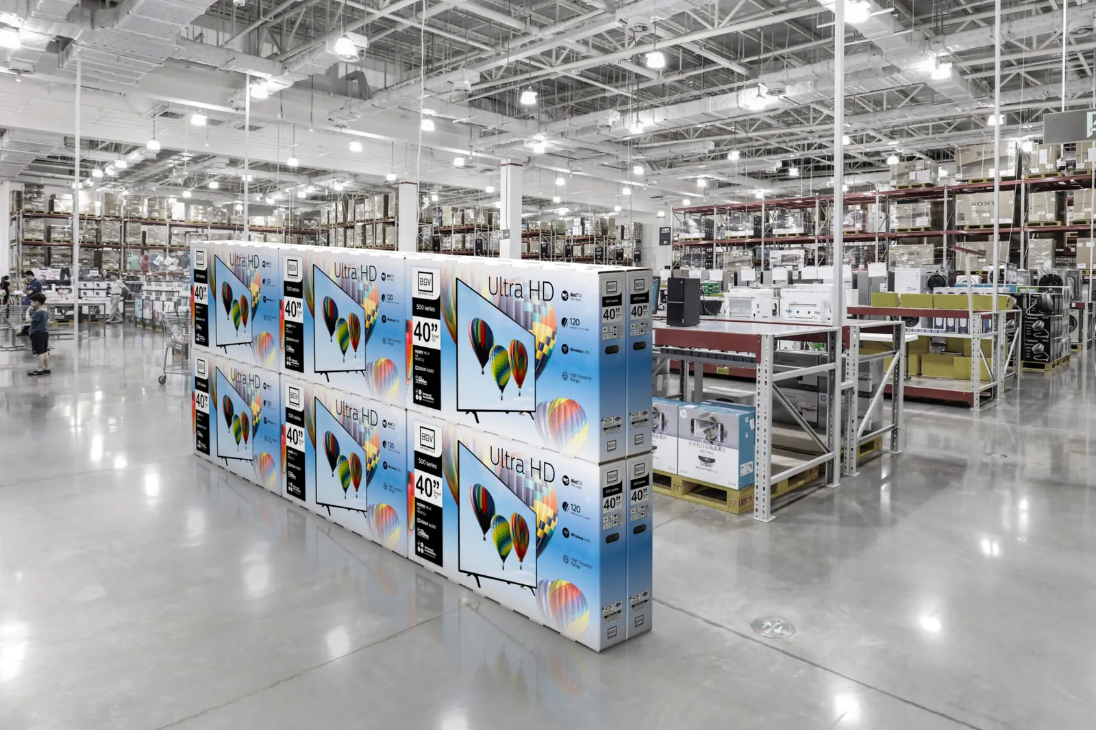 Stacks of TV boxes in a store.