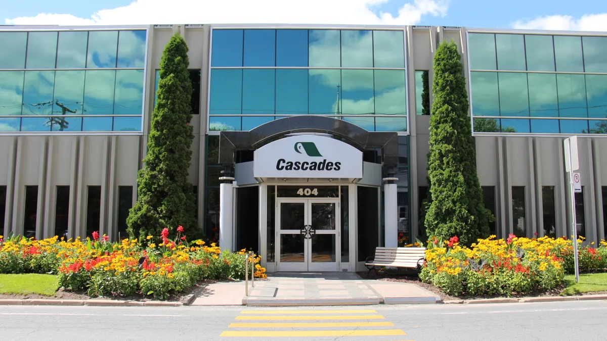 Outside view of an office building with a sign for Cascades paper.