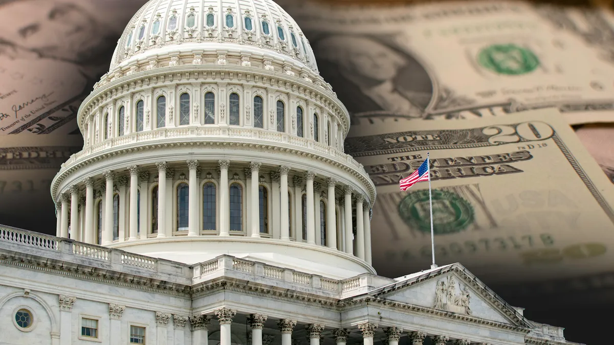 The dome of the U.S. Capitol with a U.S. flag is shown in front of a spread of dollars of different amounts in this photo image.