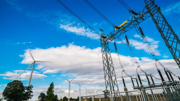 A group of wind turbines and an electrical substation.