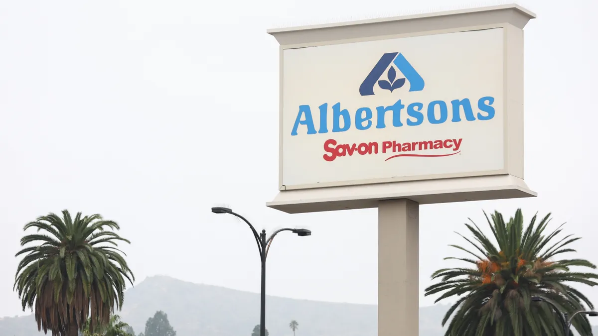 An Albertsons sign with palm trees in the background.