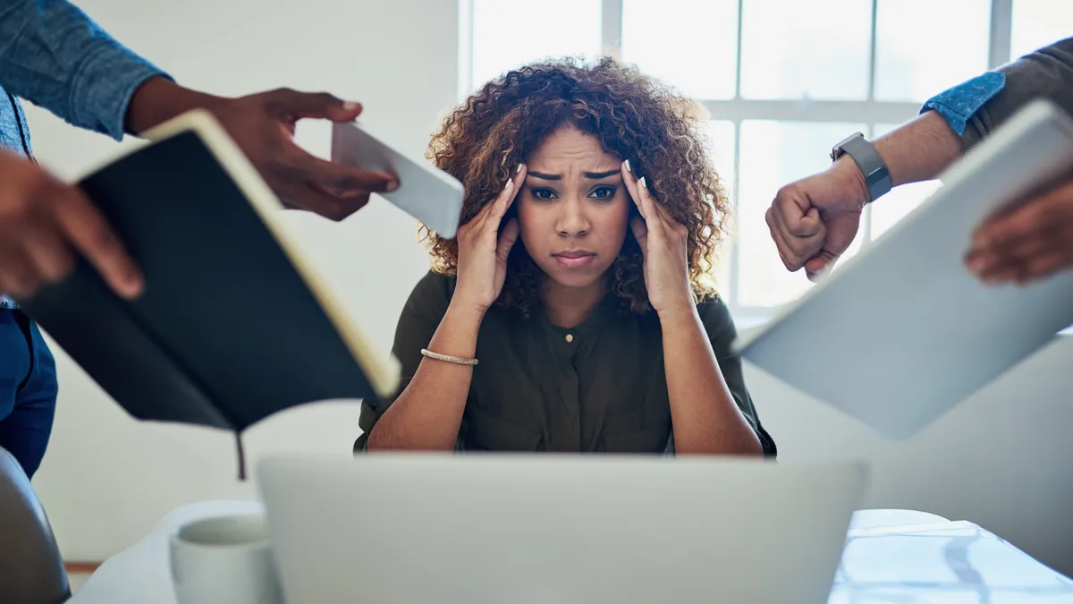 Shot of a stressed out person during a demanding day at work