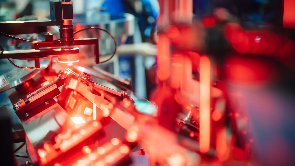 Close up view of an automated optical inspection system with industrial sensors and robotic vision technology in electronics manufacturing line