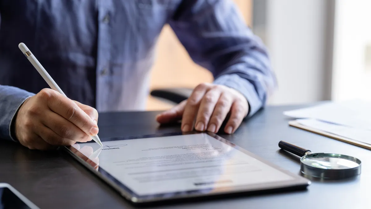 Man Signing The Digital Contract