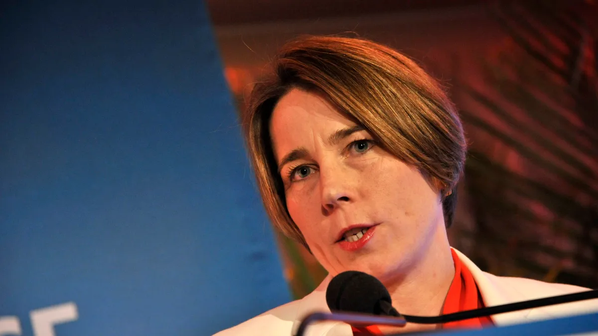 A close-up view of Massachusetts Governor Maura Healey at a podium,