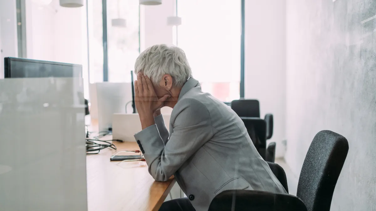 Overworked mature businesswoman in the office