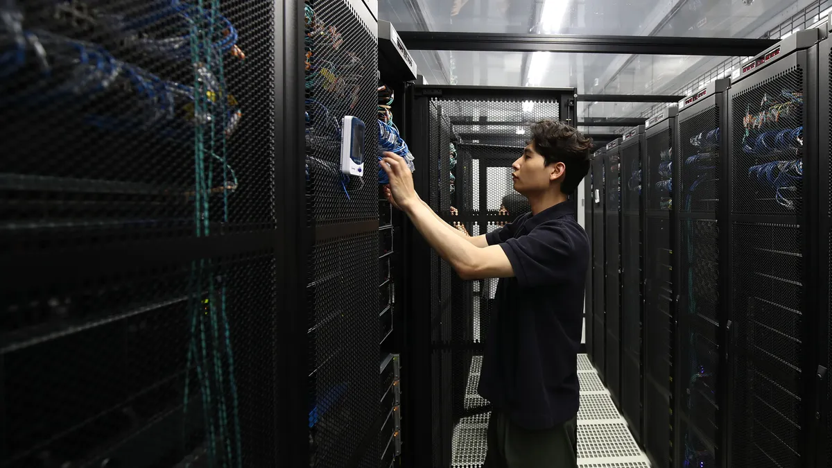 An employee checks a server room in the Samsung Networks' Telco Data Center.