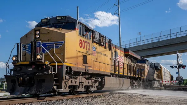 A yellow train is seen moving on a track