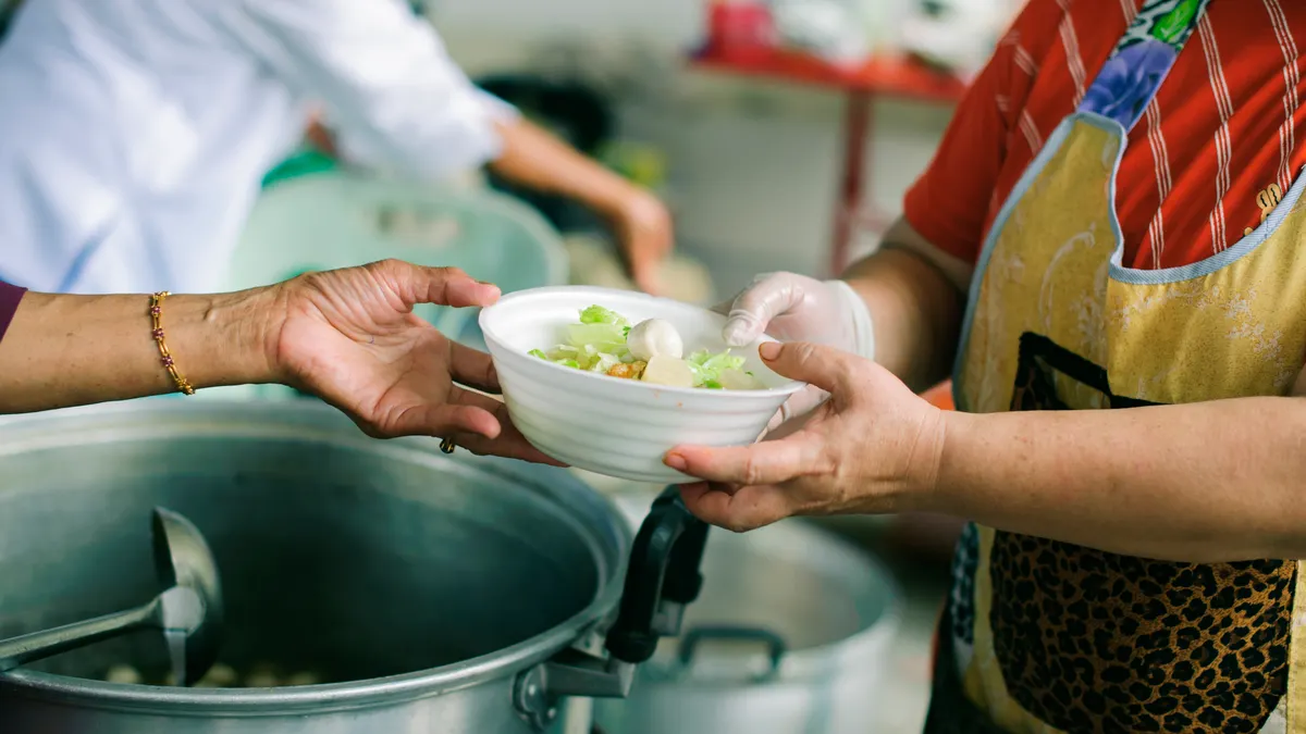 The hands of refugees have been aided by charity food to alleviate hunger