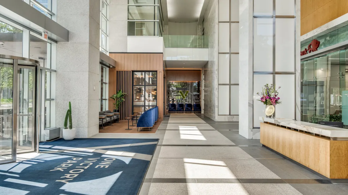 The interior of a modern office lobby.