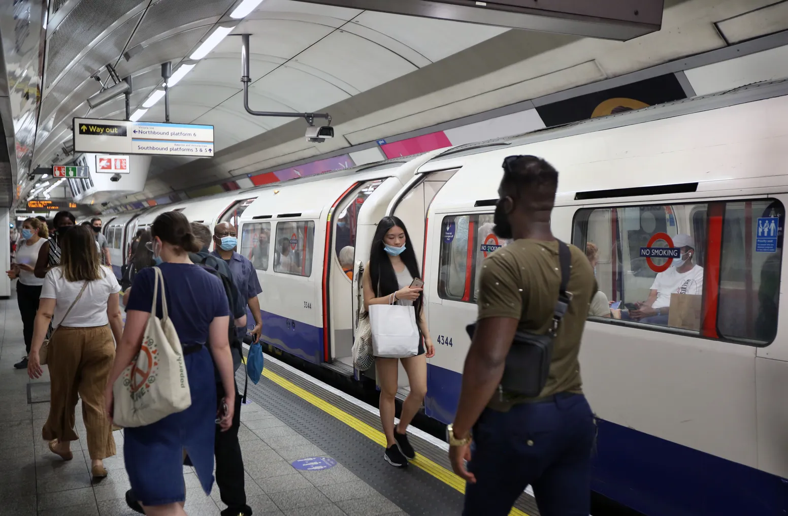 Commuters and shoppers opt to continue wearing face coverings on the London Underground system despite it no longer being enforced.