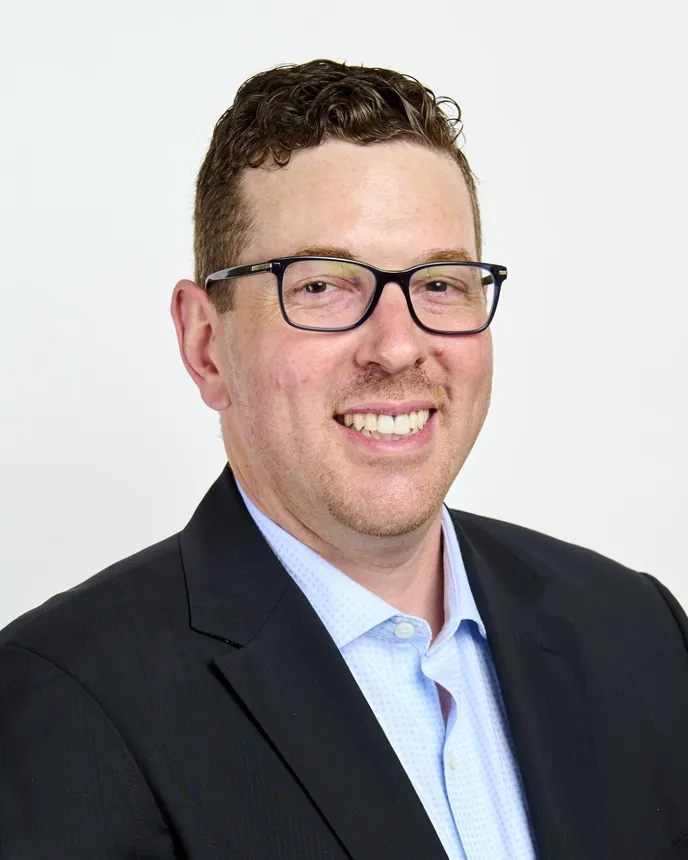 Headshot of a man in professional attire.