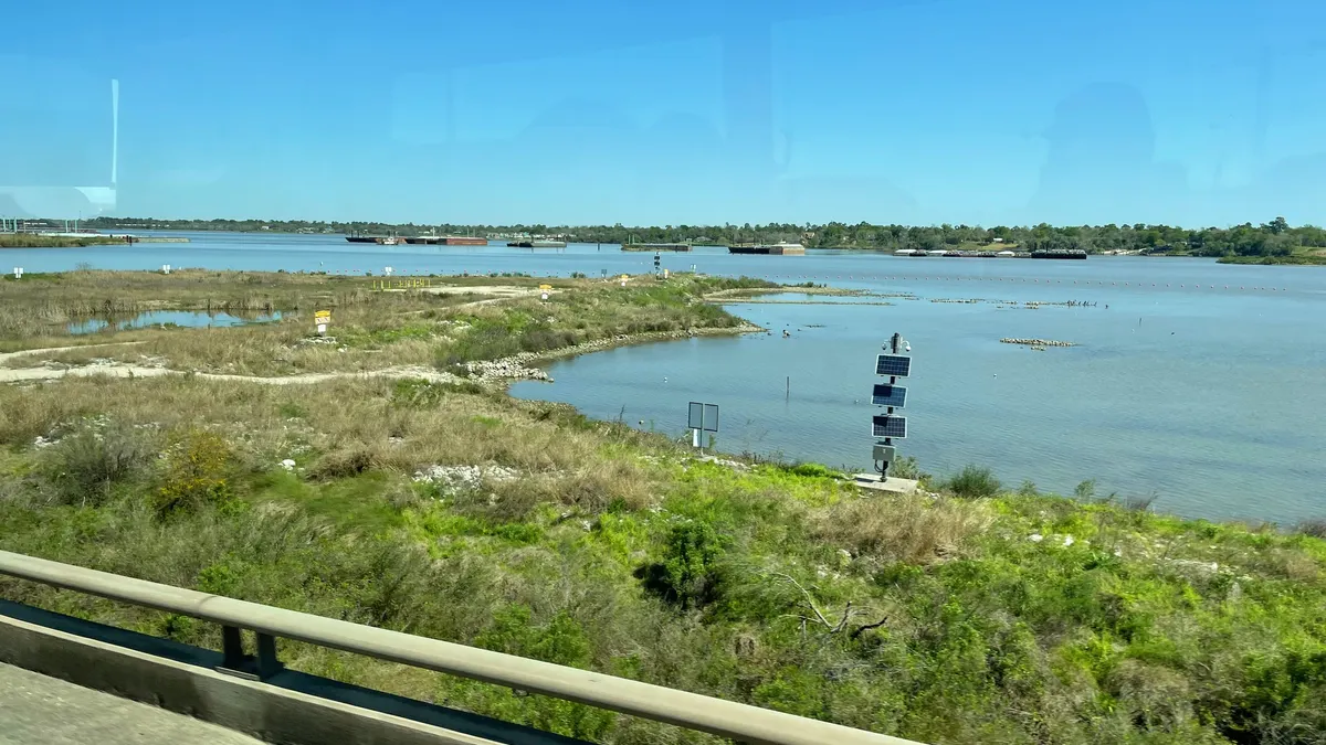 a riverbank seen from a bus window
