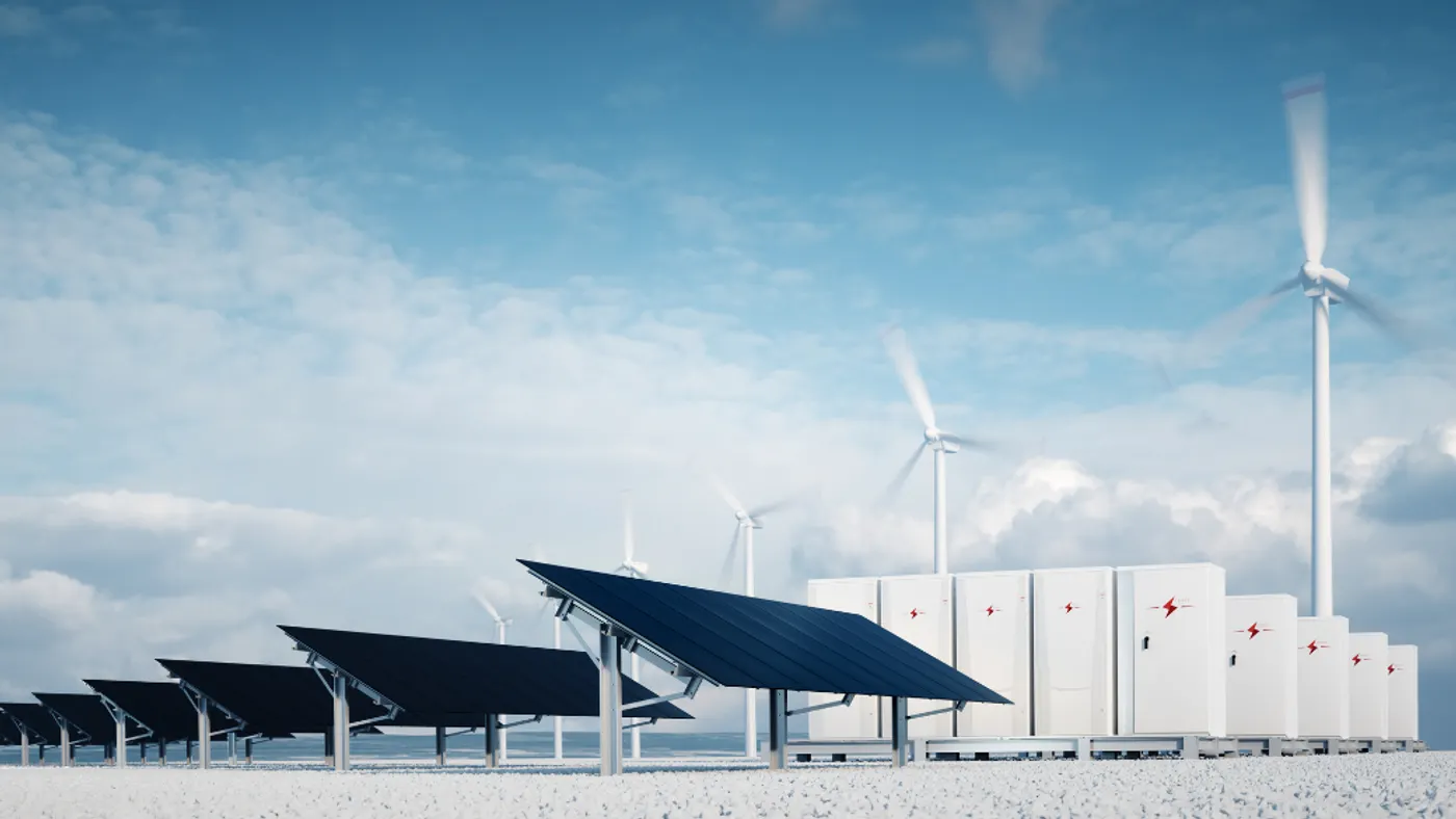Solar panels and wind turbines with partly cloudy sky.