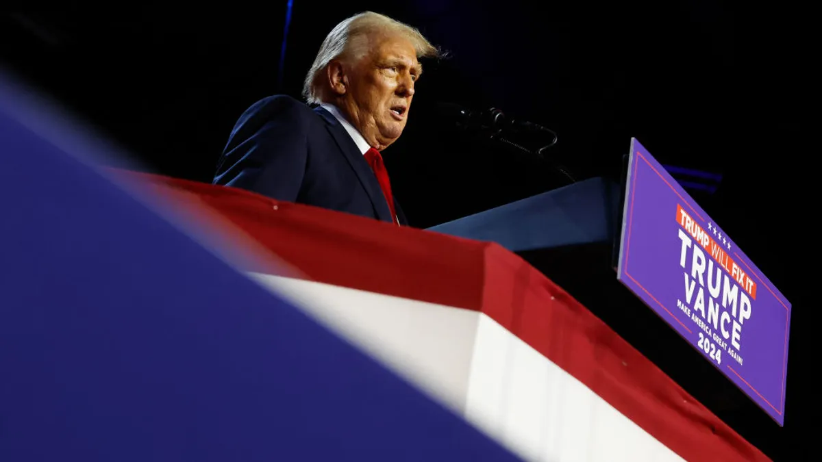 President-elect Donald Trump addresses a crowd from a podium at the Palm Beach Convention Center on Nov. 6, 2024, in West Palm Beach, Florida.