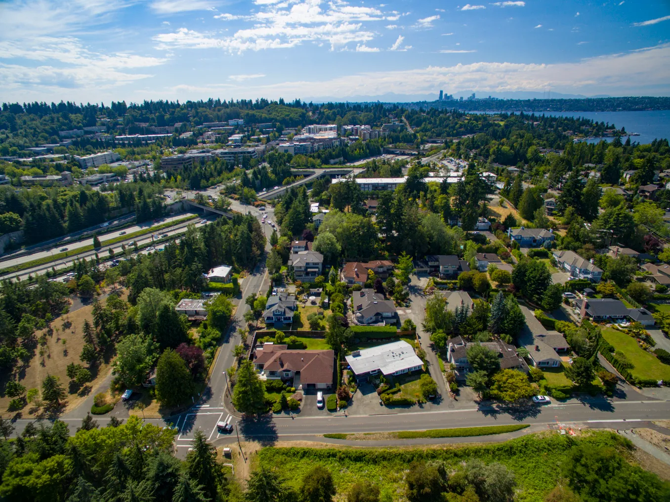 An aerial view of Mercer Island, Washington, and Interstate 90, with the Seattle skyline in the background.