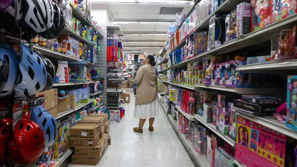 A person browses an aisle of toys.