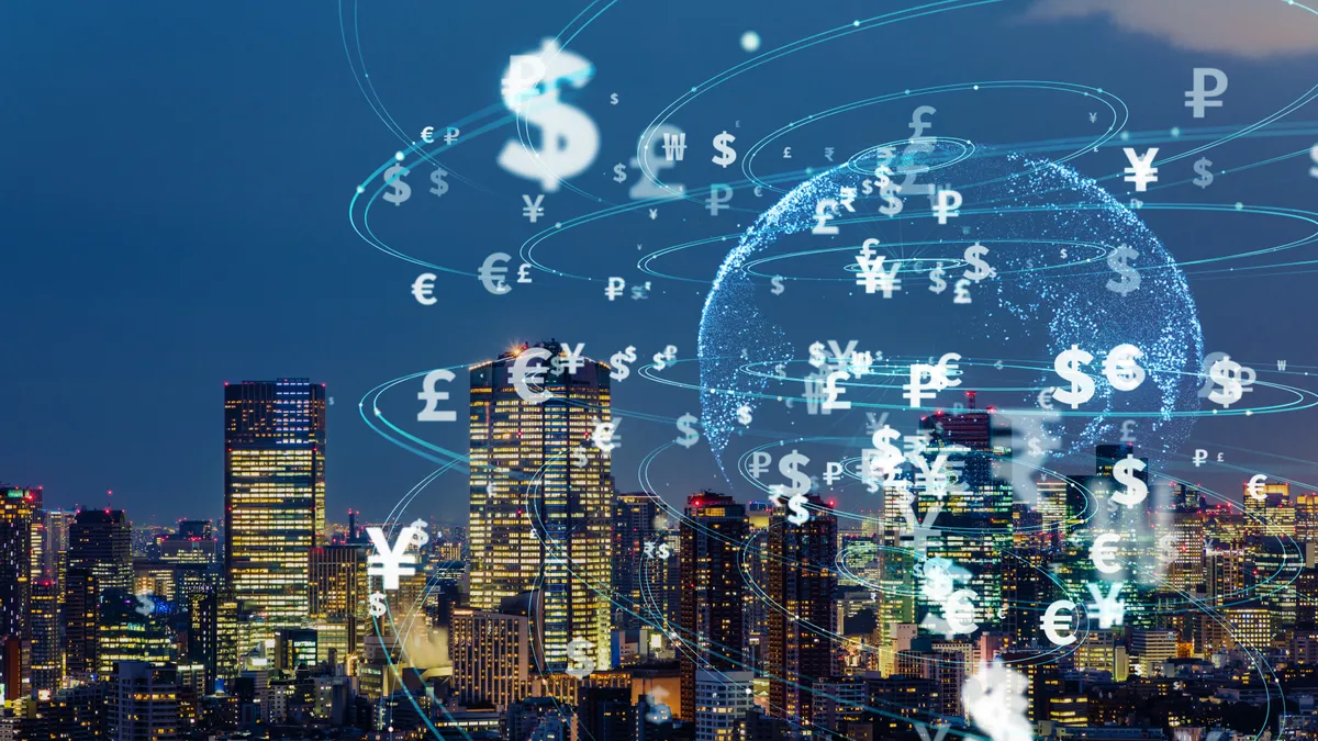 Global currency symbols with skyscrapers in background