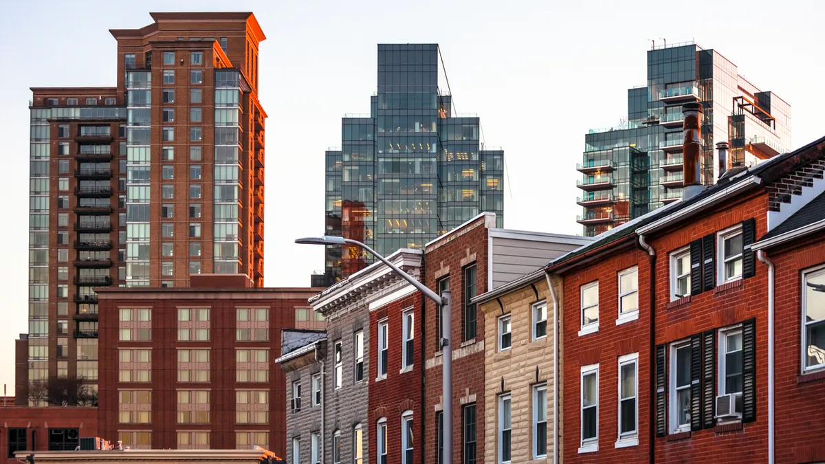 Row houses with skyscrapers in the background