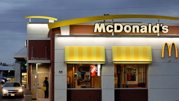 An image of a white building with yellow signage that says McDonald's