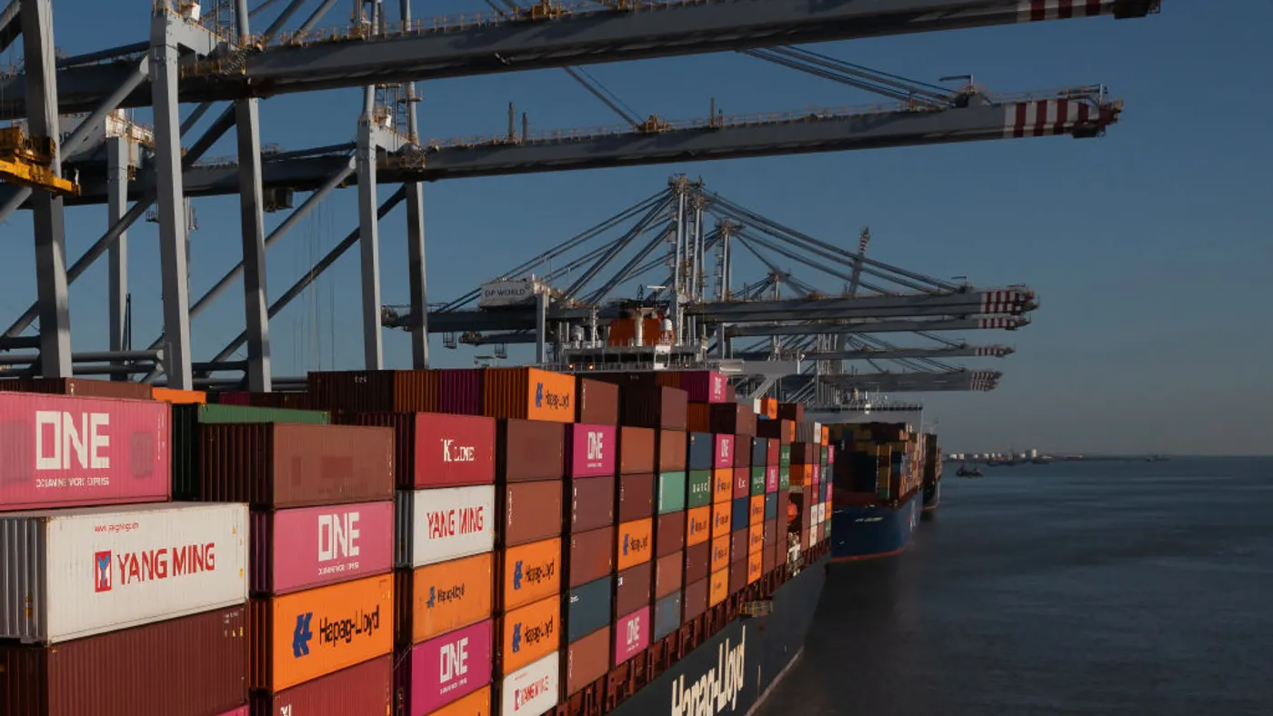 A vessel full of containers traveling through a European waterway.