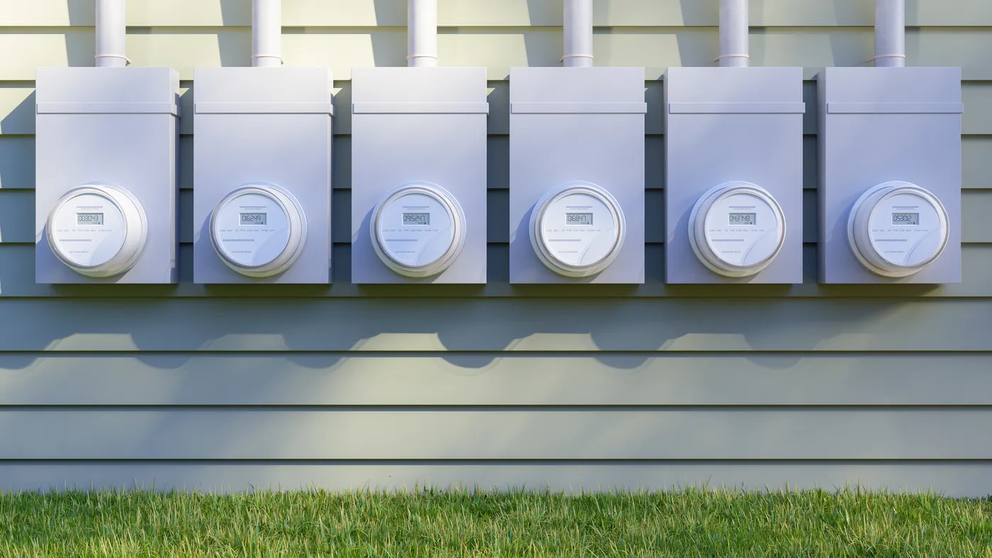 Front View Of Electric Meters On Building Facade