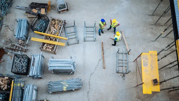 Construction materials lay on a jobsite, shown from above.