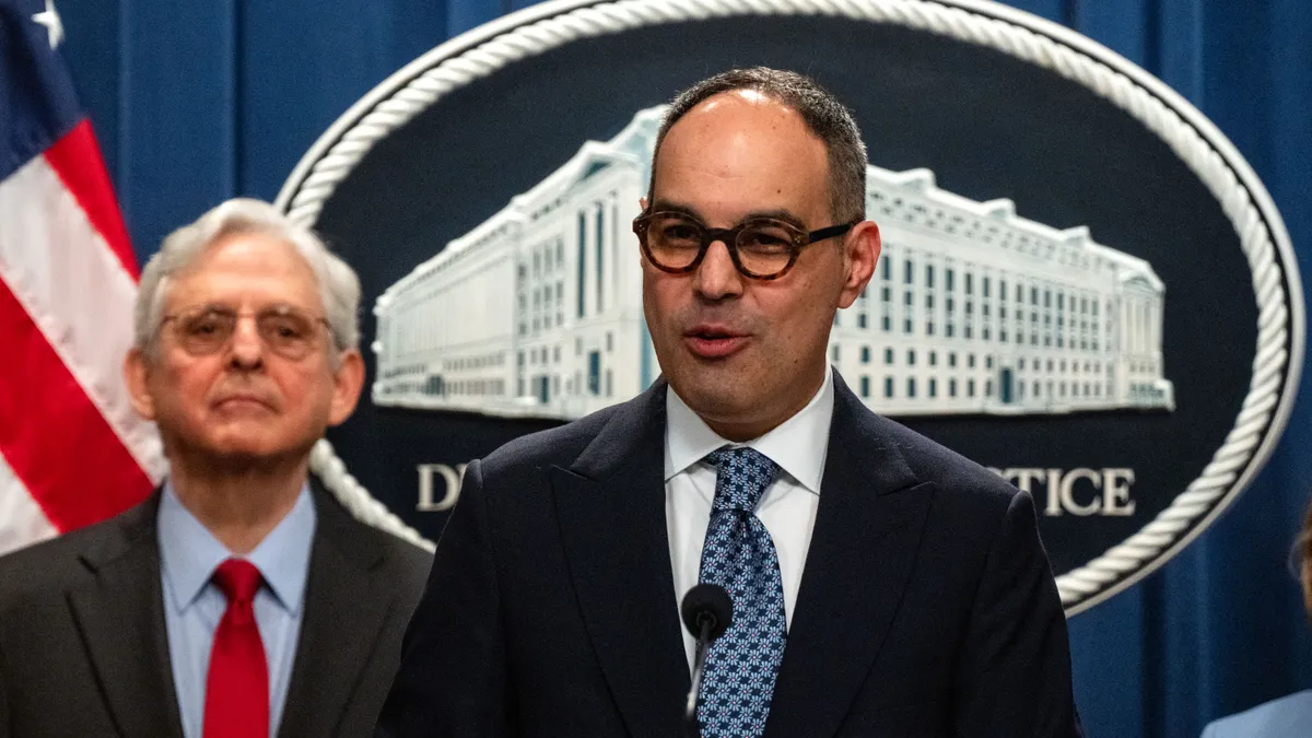 Jonathan Kanter, Assistant Attorney General for the Department of Justice Antitrust Division, speaks as U.S. Attorney General Merrick Garland listens, during a news conference at the Department of Justice Building in Washington, D.C.