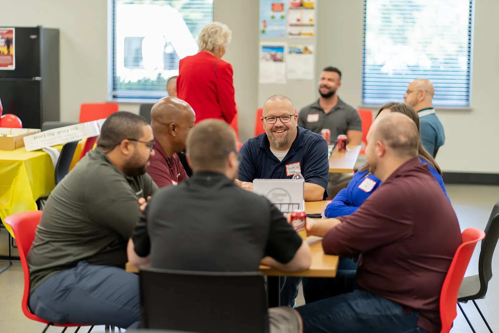 Estes workers at a table to commemorate the expansion of the carrier's network.