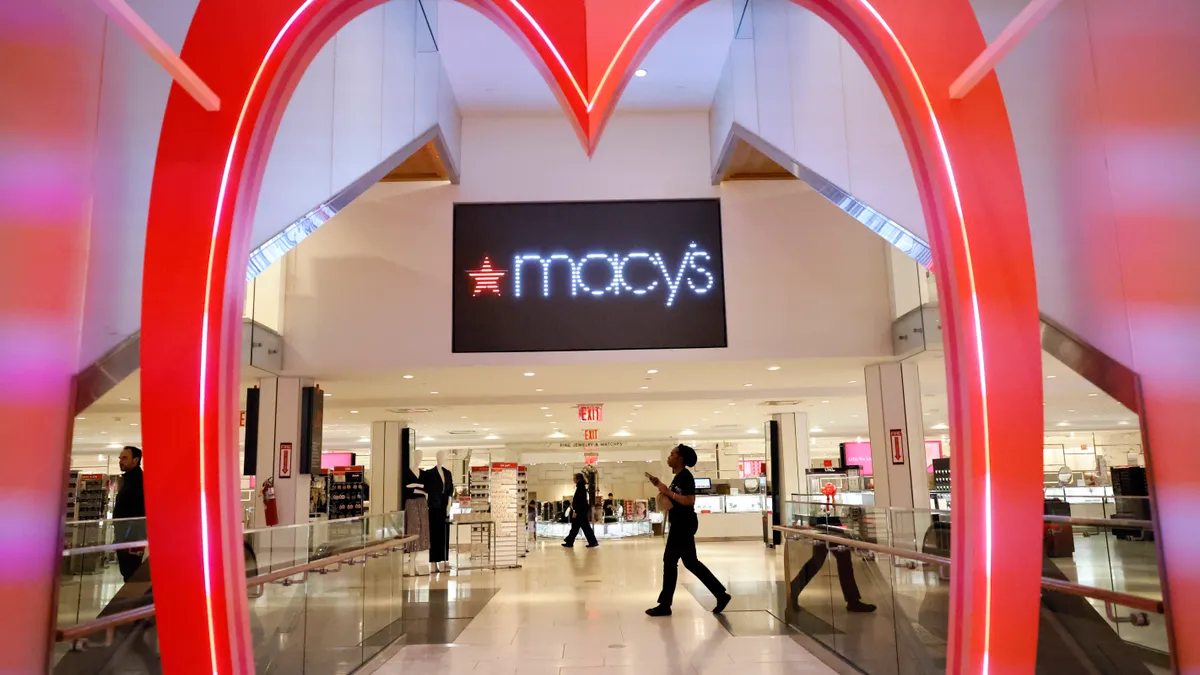 The Macy's logo at the entrance to a mall store