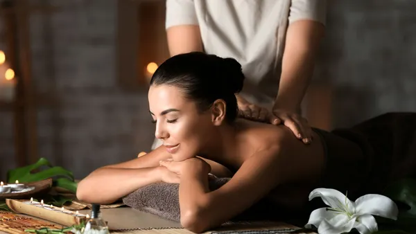 Woman getting a back massage at a spa.
