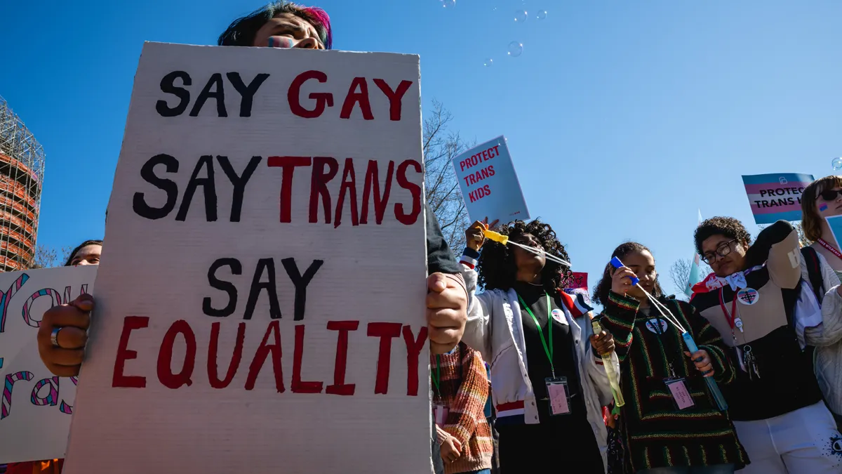 A person with a sign stands at a rally on March 29, 2023 at the Kentucky State Capitol in Frankfort, Kentucky.