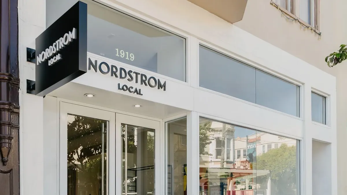 A storefront, with the neighborhood reflected in the window.