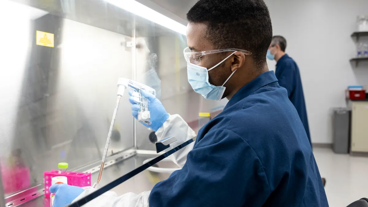 Man in medical lab manufacturing DNA.