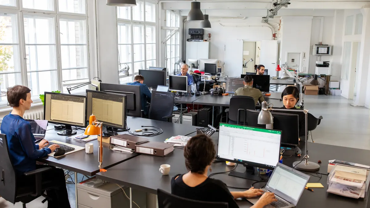 Business people working in an open plan office
