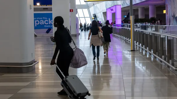 A traveler pulls a suitcase through an Amtrak terminal.