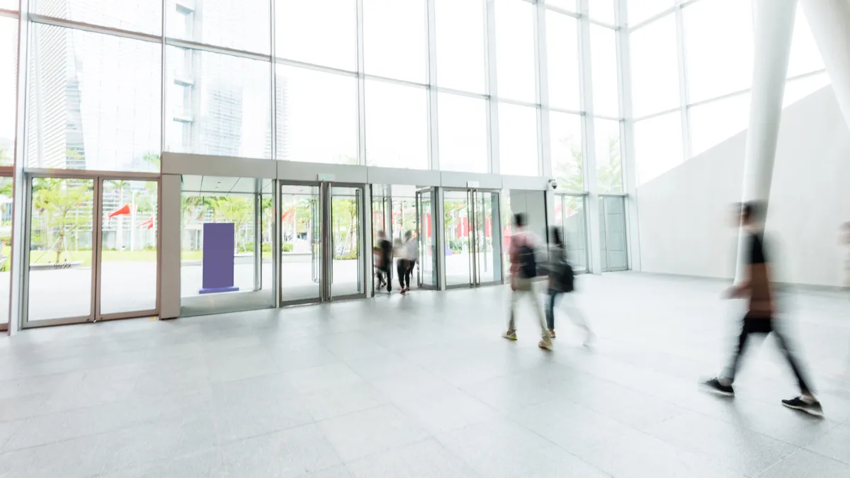 Group of people walking in modern building lobby