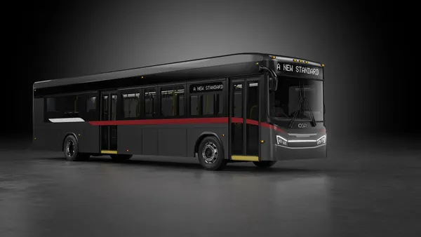 A dark gray bus on a gray background.