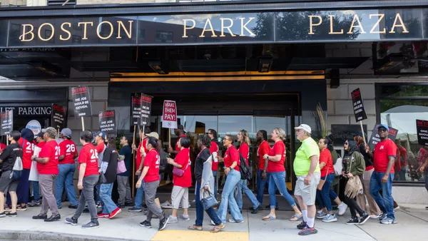 Workers hold picket signs outside the Hilton Boston Park Plaza.