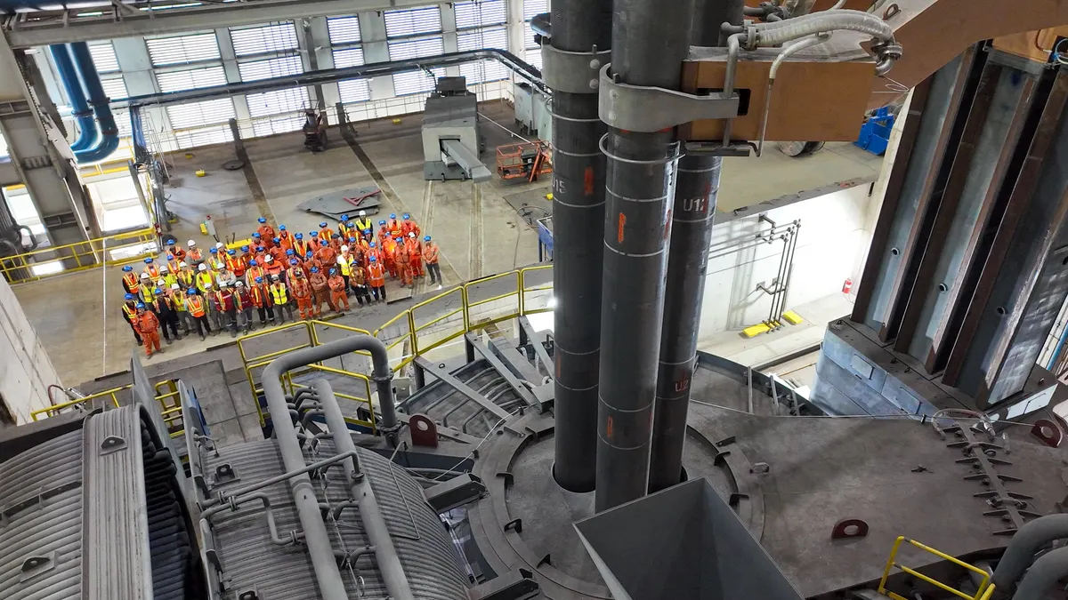 Algoma Steel workers stand in front of the company's new electric arc furnace.