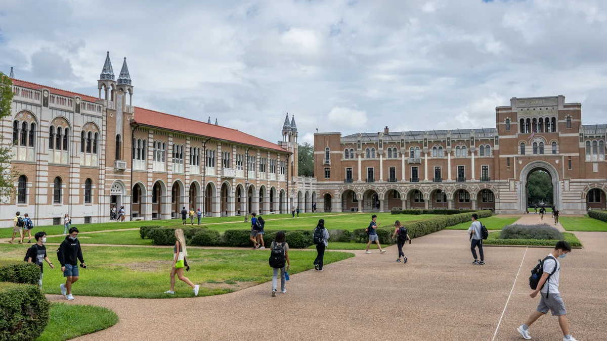 Students walk to class on Rice University's campus.