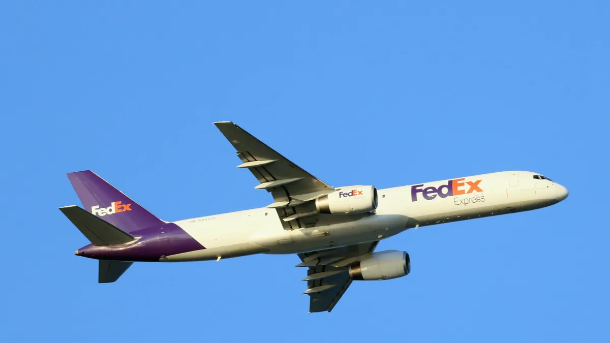 A Federal Express cargo plane flies over Nickerson Beach on July 20, 2022 in Lido Beach, New York, United States.